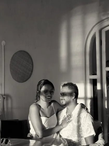 A quiet moment in a beachside cafe. The beautiful play of light and shadow in this black and white photo creates a soft, intimate, and timeless portrait.