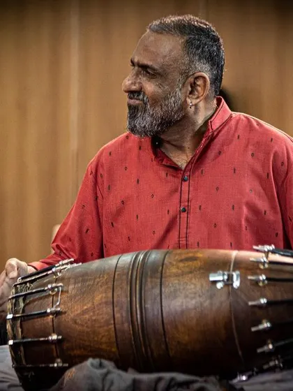 A close-up of Jayachandra Rao, a master of the mridangam. His powerful and precise playing provides the rhythmic drive for our traditional and fusion pieces.