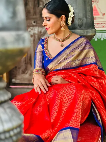 Another shot of me in the red and blue saree, highlighting the beautiful texture and sheen of the silk.