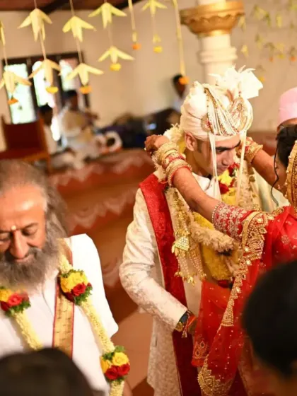 The sacred Varmala ceremony, where Nikita and Pranav exchange garlands in the presence of Gurudev, symbolizing their mutual acceptance and the beginning of their life together.