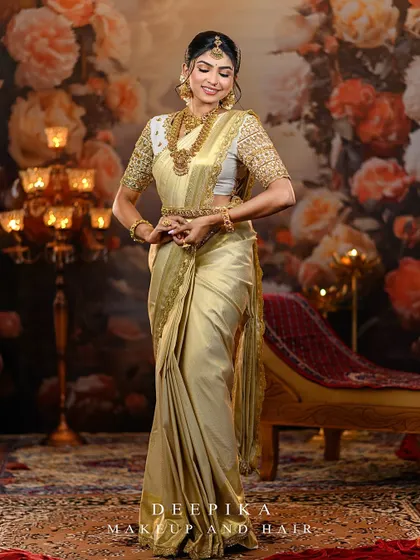 A full-length shot of the model, capturing the grandeur of the golden saree and the elegance of our custom designer blouse.
