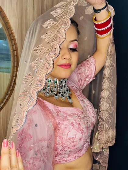 This pose with the veil showcases the elegant embroidery on the dupatta and the bride's confident posture.