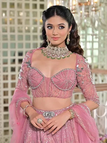 The details of this pink lehenga are exquisite. My draping style ensures the embellished blouse and belted waist are highlighted, creating a structured and flattering silhouette.