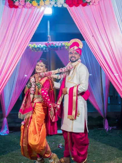 The couple exchanges garlands in a playful moment during their varmala ceremony.