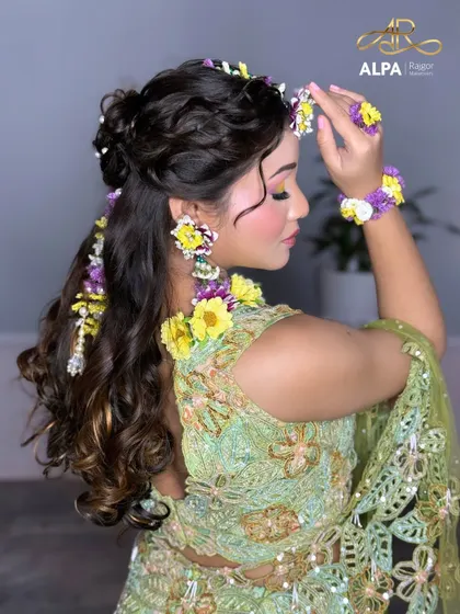 A side profile view that gives a better look at the floral earrings and the intricate hairstyle.