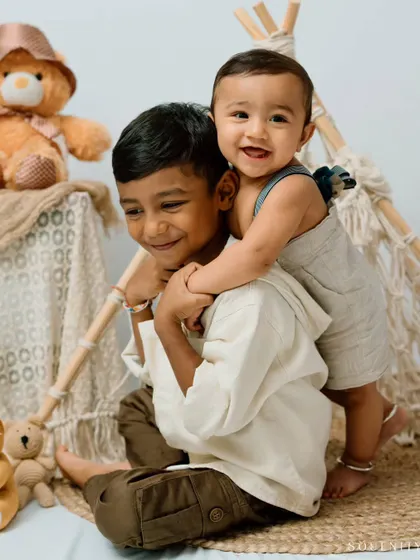 The best hugs are from a big brother. This photo is a heartwarming testament to the special bond that siblings share from the very beginning.