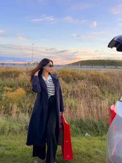 A windswept shot against a beautiful sunset sky, highlighting my long trench coat.