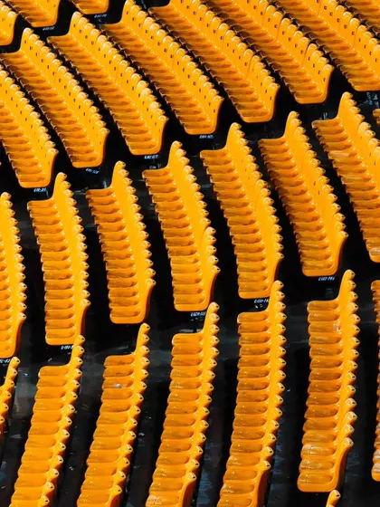 The vibrant yellow seats of the stadium in Gwalior, captured before the crowds arrive. These shots help set the scene for the event.