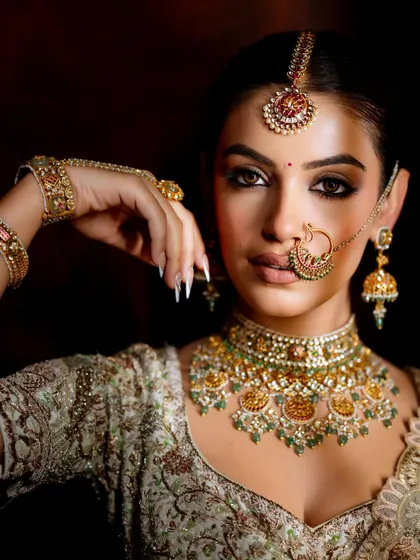 Another powerful close-up of this intense look. The focus is on the perfectly blended eyeshadow, sharp contour, and the stunning bridal jewelry that complements the makeup.