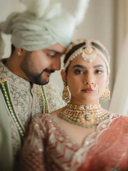 An intimate close-up that feels both artistic and emotional. The soft focus and gentle embrace highlight the couple's connection.