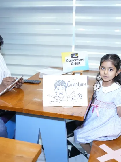 A guest proudly shows off her caricature portrait. Our caricature artist add-on provides a unique and fun party favor for kids to take home and remember the special day.