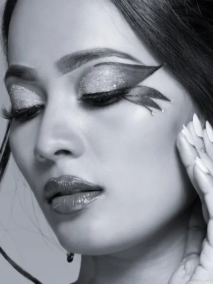 A black and white version of a beauty shot, highlighting the glitter and texture of the makeup.