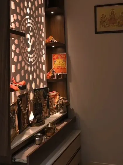 A beautifully lit puja unit with an intricate 'Om' jali design, creating a serene and spiritual corner in the home.