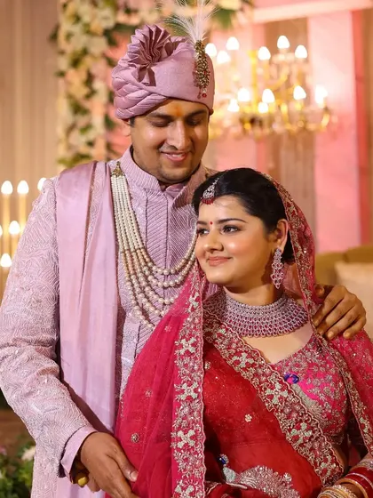 A classic portrait of the wedding couple, with the groom's arm gently around his bride.