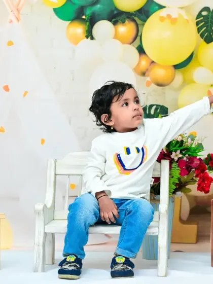 Interacting with the 'TWO' blocks, this toddler is actively engaged in his second birthday session. I encourage play to capture natural and candid moments.