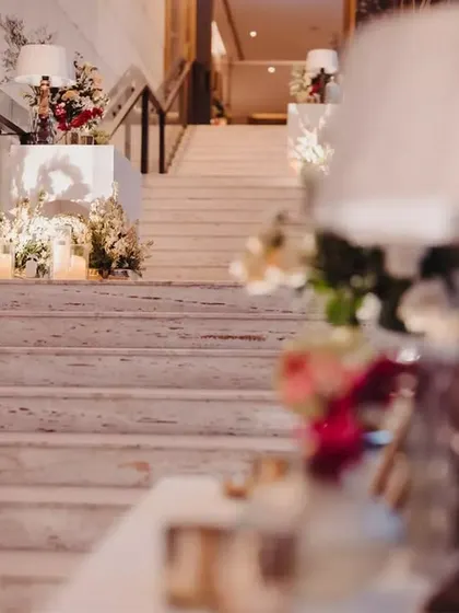 Even the stairways deserve a touch of elegance. We decorated the grand staircase with floral arrangements and statement lamps, ensuring every part of the venue felt special.