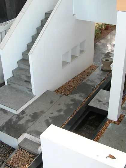 The interplay of levels, stairs, and water features at the Stuber Hall project. Our design creates a journey through the space, with intersecting planes of concrete and water guiding movement and creating moments of pause.