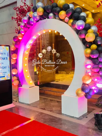 A modern, light-up entrance arch decorated with balloons for a stylish 18th birthday party.