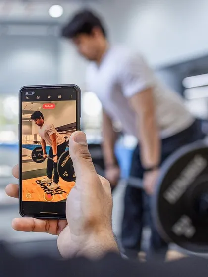 Every movement is analyzed. A coach records a trainee's deadlift form for detailed feedback and technical correction.