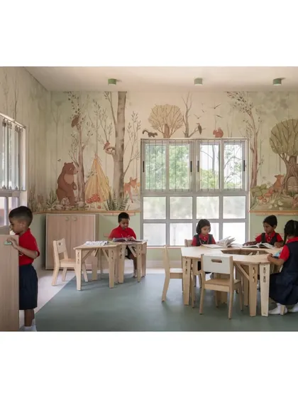 Students engaged in reading in the forest-themed classroom. The natural materials and calming color palette create a peaceful environment that is conducive to focused learning and quiet activities.