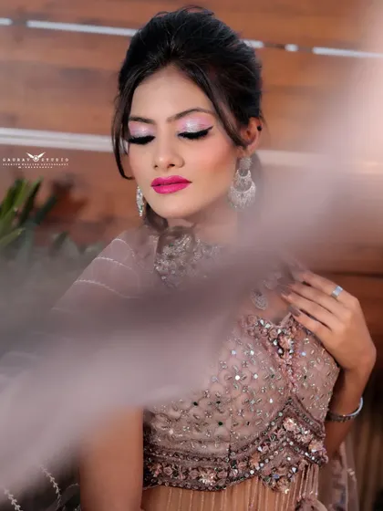 An artistic shot with a soft, hazy foreground element. This creates a dreamy and romantic mood, focusing on the bride's serene expression.