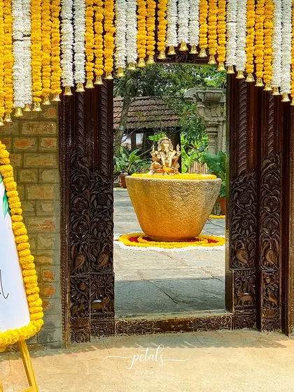 A closer look at the entrance, with the personalized welcome board framed by marigolds. The open doorway offers a tantalizing glimpse of the decor inside.