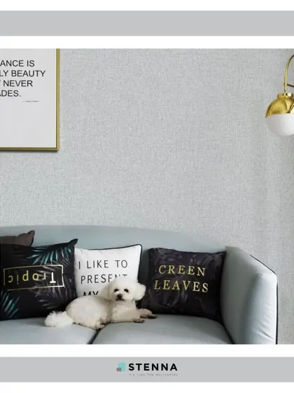 A cozy living room scene featuring a subtle grey textured wallpaper. This image shows how a simple, high-quality wallpaper can serve as a sophisticated backdrop, allowing your furniture and decor to shine.
