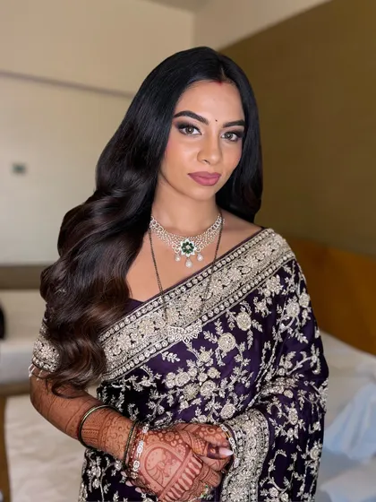 A portrait showing the complete look. The makeup features a soft smokey eye and a matte lip, perfectly complementing the elegant saree.
