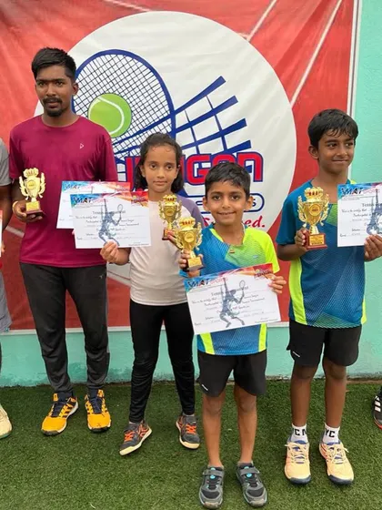 A group photo of the young winners with a coach.