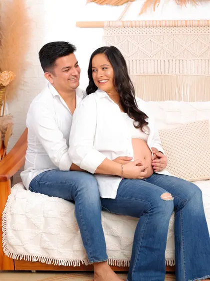 An intimate and happy moment shared on our studio's boho-themed set. The natural textures and warm lighting create a comfortable and loving atmosphere.