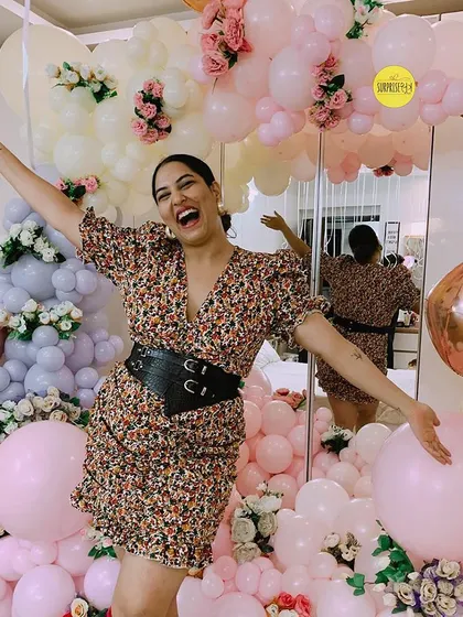 Influencer Sakshi Sindwani looking joyful and radiant, surrounded by a room full of our pastel balloon creations for her birthday.
