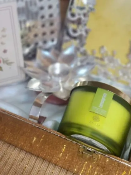 A close up on the large, fragrant EKAM lemongrass candle, a centerpiece in our festive collaboration hamper.