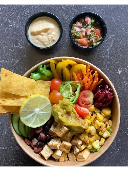 The Mexican Fiesta Salad Bowl is like a healthy plate of nachos. We combine chargrilled corn, black beans, and spiced tofu with fresh vegetables, and serve it with our own vegan cauliflower cheese sauce and pico de gallo.
