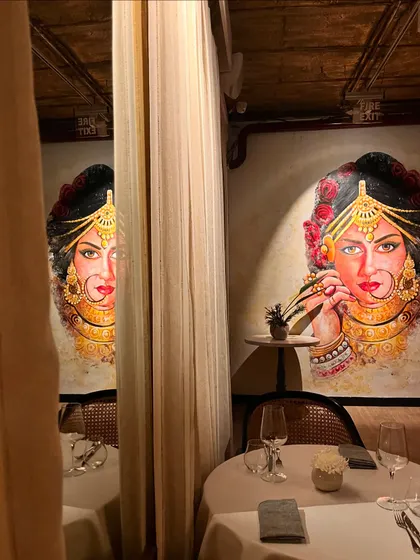 A striking mural of a royal Indian bride serves as a captivating focal point in one of our dining sections. It adds a touch of artistic soulfulness to the space.