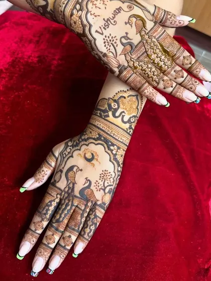 A graceful design featuring peacocks and the moon. The name 'Vishwam' is beautifully integrated into the artwork.