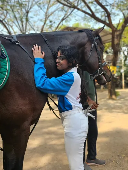 A quiet moment of connection between a rider and her horse after a training session. This bond is the heart of equestrianism and what we strive to nurture in every student.