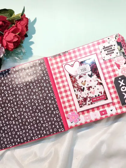 A page from an anniversary scrapbook with a shaker window and a gingham pattern.