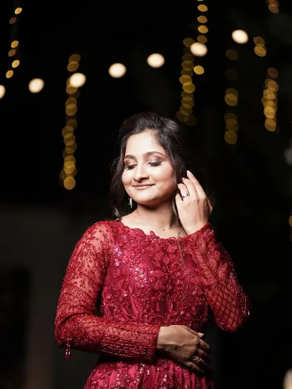 Monica looking absolutely dreamy for her reception. The soft, romantic makeup with a touch of shimmer on the eyes perfectly complements the magical, fairy-light ambiance.