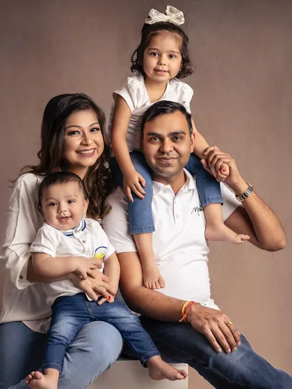 Sometimes the most classic look is the most timeless. This family portrait, styled in simple white shirts and denim, feels so natural and relaxed, letting their happy smiles shine through.