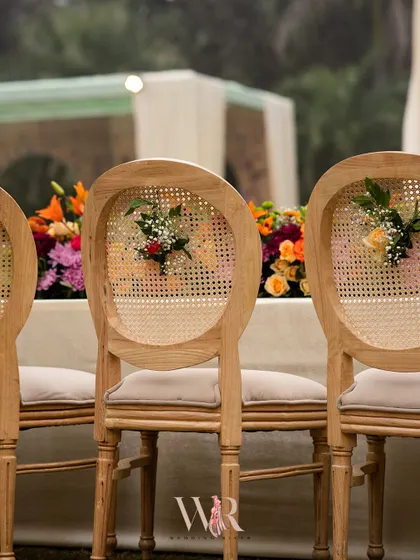 A small detail that makes a big impact. We added small, fresh floral bouquets to the backs of the cane chairs to carry the garden theme throughout the entire seating area.