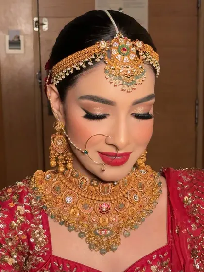 A detailed close-up of the eye makeup and bold red lip. The Fenty Beauty MVP lipstick provides a powerful, long-lasting color that is perfect for brides.