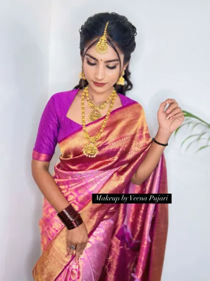 This client looks stunning in her pink silk saree. The makeup is soft and pretty, with a focus on glowing skin.