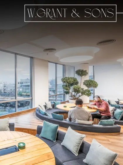 This collaborative space at William Grant & Sons features sunken circular seating and large windows for ample natural light. As the general contractor, I focused on executing the warm minimalist design with precision.