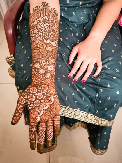 A single arm shot of a beautiful and intricate bridal design.
