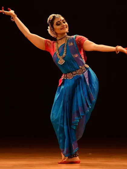 A dynamic pose from an endowment programme performance, capturing the fluid energy of the dance form.