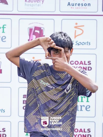 A young player frames a shot with his hands, showing his creative and fun-loving spirit at the Junior Fives League.