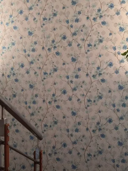 This blue floral wallpaper brings a fresh and airy feel to a staircase wall. The delicate pattern adds a touch of color and nature, brightening up the space and making it feel more open.