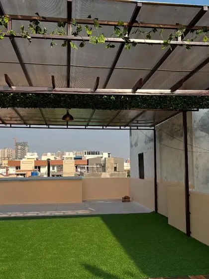 Another angle of the rooftop terrace with artificial grass, showing the full extent of the open, green space created.