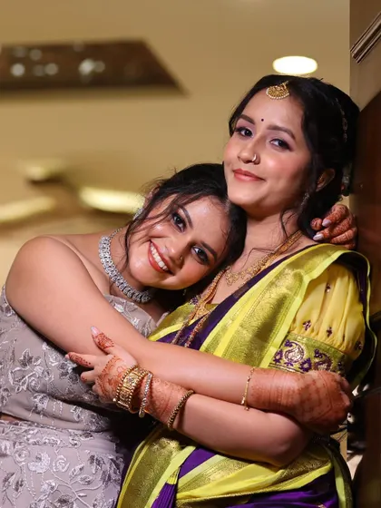 A heartwarming shot of the sisters. One is dressed for the engagement in a traditional saree, while the other is in a modern gown, showcasing my versatility.