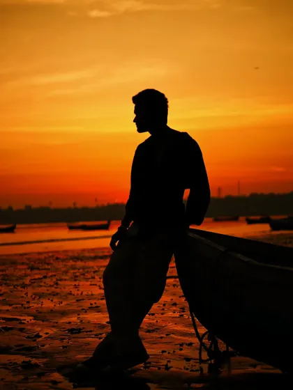 A profile silhouette that clearly defines the model's form against the vibrant sky.